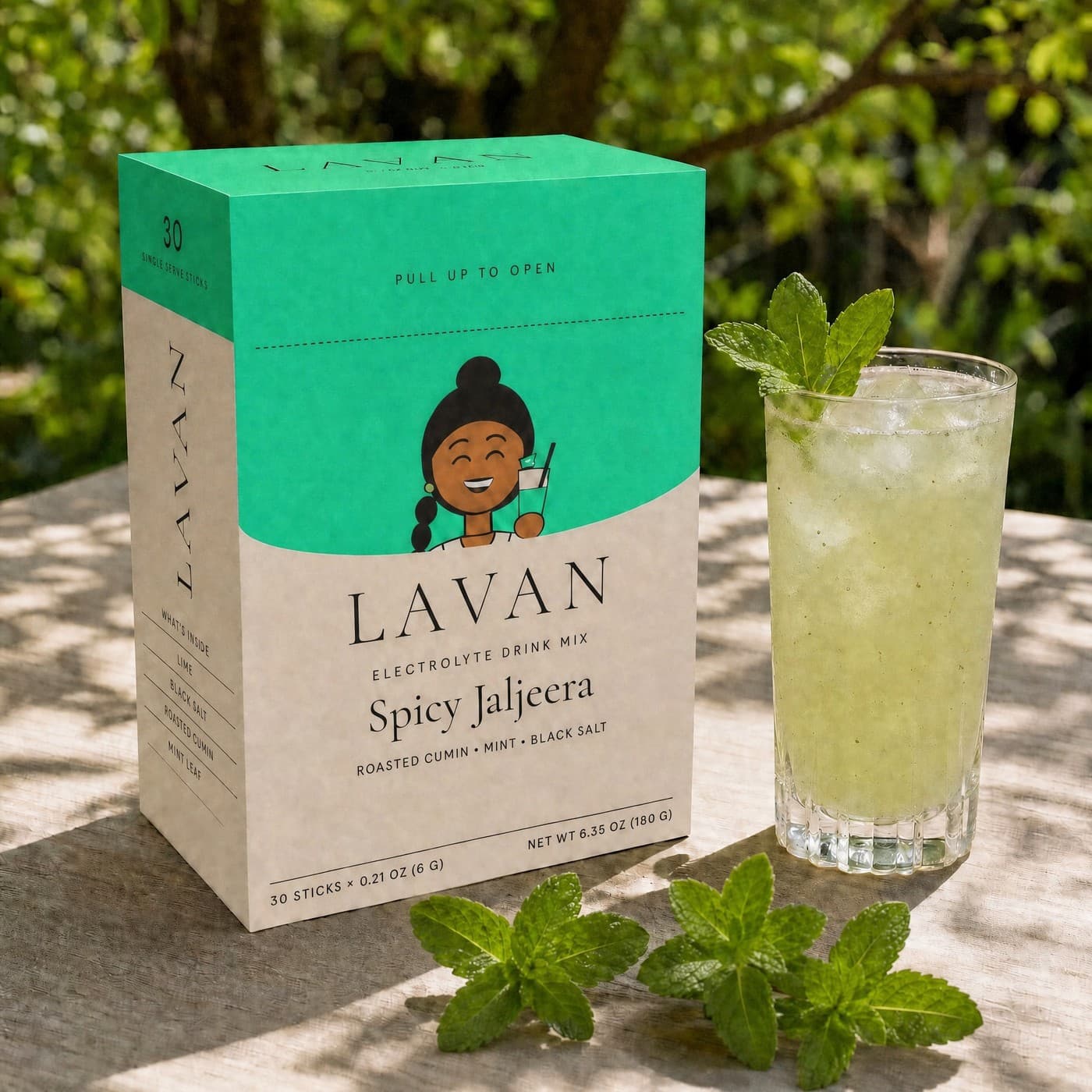 Spicy Jaljeera box next to an iced glass of jaljeera